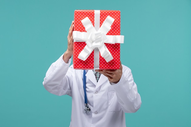 Medic care tine in mana un cadou de Crăciun
