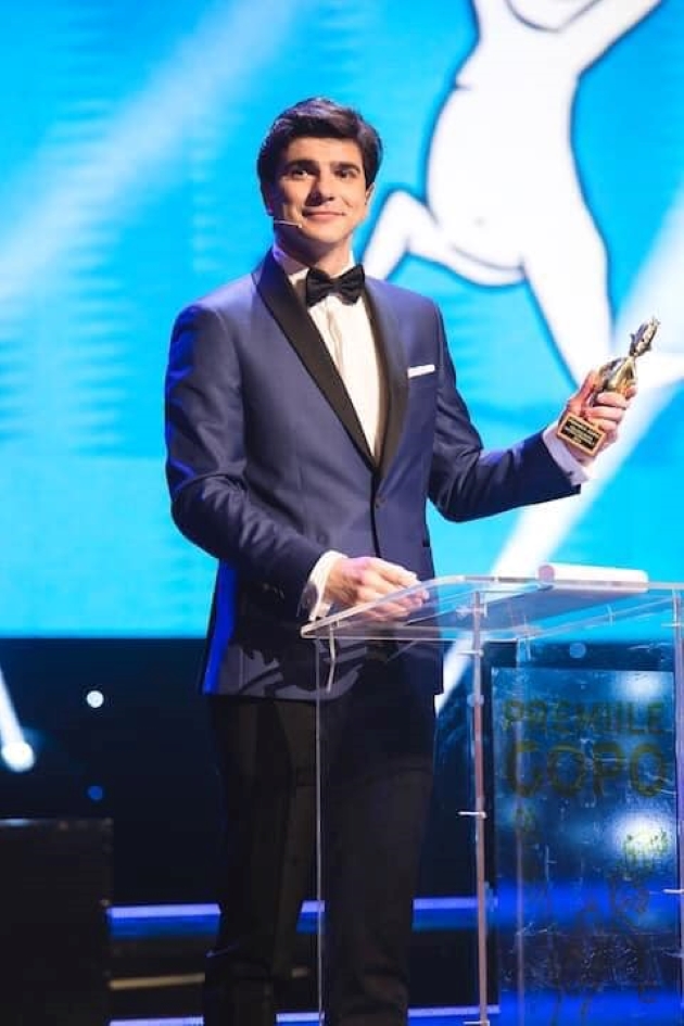 alex bogdan imbracat intr-un costum albastru la ceremonia premiilor gopo