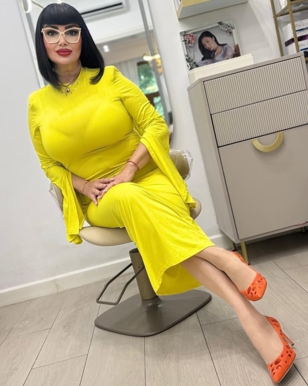 ozana barabancea sta pe scaun imbracata intr-o rochie galbena