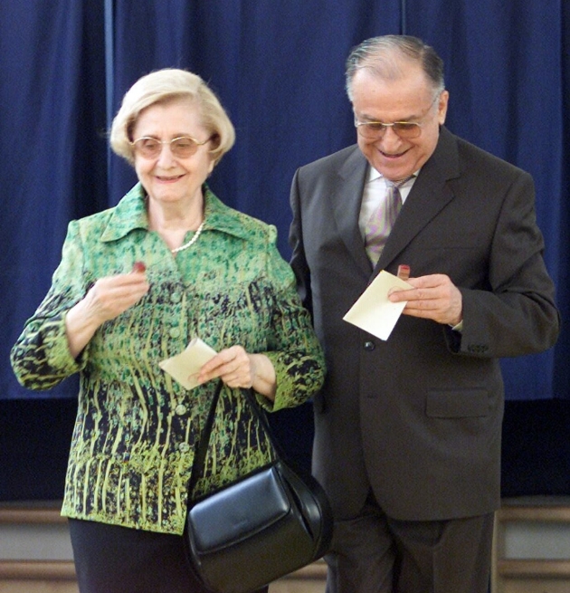 nina si ion Iliescu impreuna la o sectie de votare zambitori cu buletinele de vot in mana