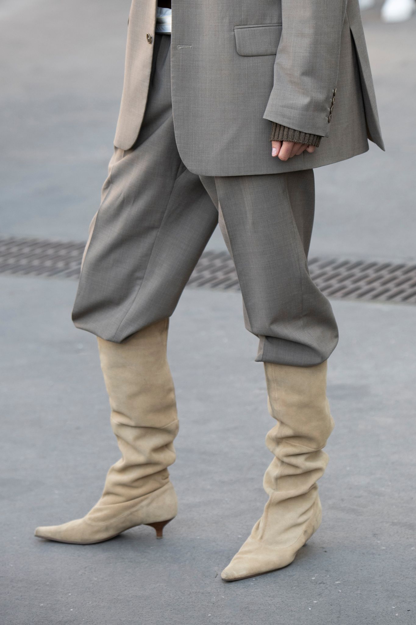 PARIS, FRANCE - FEBRUARY 28: Fashion director of Vogue Ukraine Julie Pelipas wears a Turo suit and suede knee high boots 