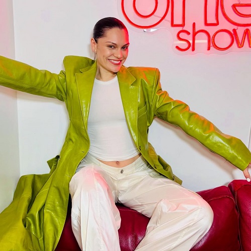 cantareata britanica Jessie J, vesela, imbracata intr-o haina verde