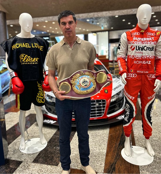 Mihai Leu aratandu-si centurile si tinutele purtate in meciuri de box si in cursele de raliuri