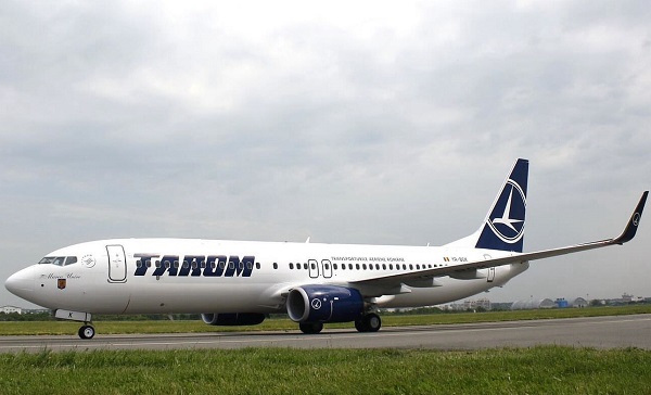 avion al companiei TAROM aflat pe o pista intr-o zi cu cer noros