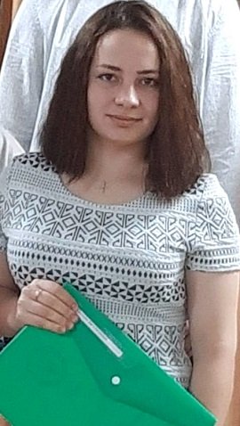 Dașa Sergienko, tanara care a murit incercand sa-si salveze sora dintr-un bombardament rusesc, imbracata cu tricou alb cu imprimeu negru si tinand in mana o mapa verde, in spatele ei aflandu-se o persoana imbracata in alb