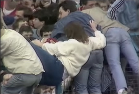 captură video de la meciul Liverpool-Nottingham Forest din anul 1989, de pe stadionul Hillsborough din Sheffield, femei si barbati incercand sa escaladeze gardurile care sa scade din busculada creata