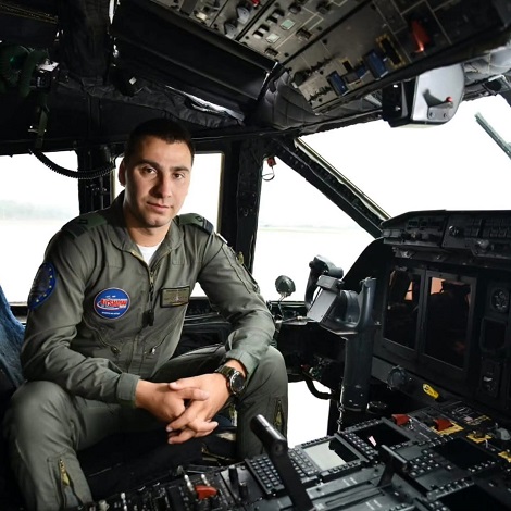 pilotul militar Mihai Vîrdol, de la Baza 90, ingandurat,în uniforma, stand cu palmele incrucisate pe scaunul de la bordul aeronavei militare pe care o pilota