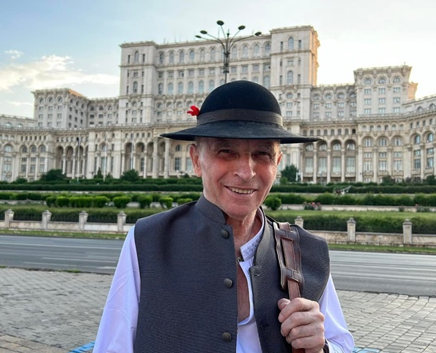 Grigore Leșe îmbrăcat în haine populare în fața palatului parlamentului
