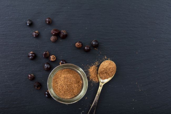 lingurita cu cafea cu guarana alaturi de boabe pe un blat de bucatarie