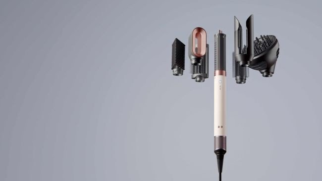aparatul dyson pe fundal gri impreuna cu capetele sale detasabile