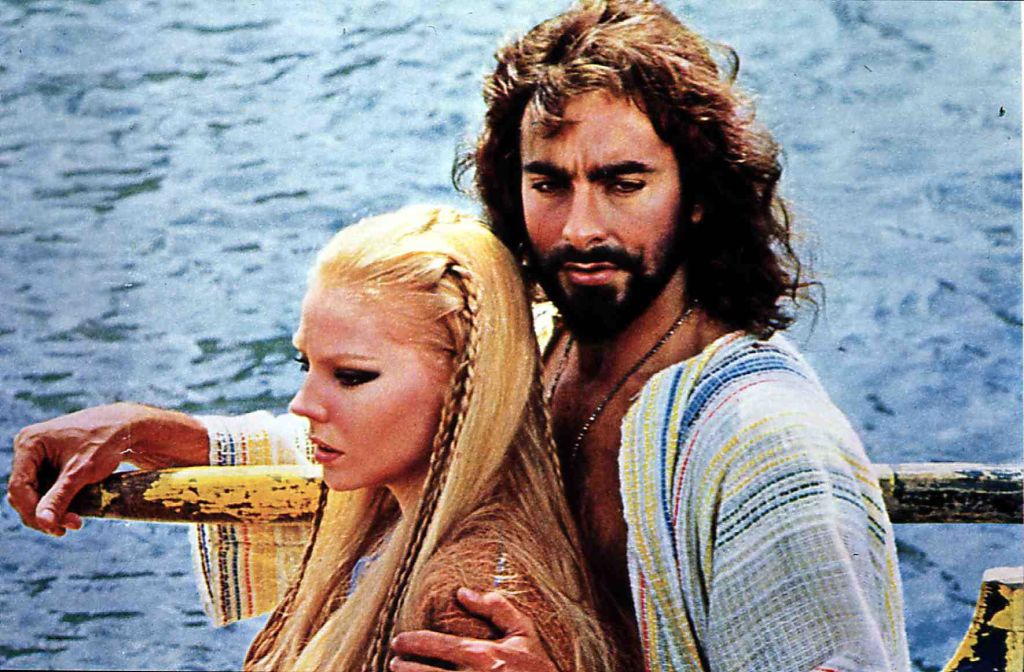 Kabir Bedi interpretând rolul lui Sandokan alături de o actriță, pe marea din Italia 