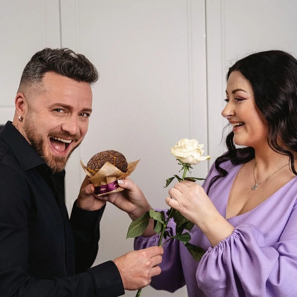 gabriela cristea alaturi de sotul sau tavi clonda cu o prajiitura si floare in mana