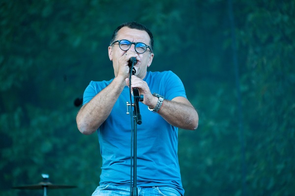 mihai margineanu pe scena imbracat in tricou albastru cu microfon in mana