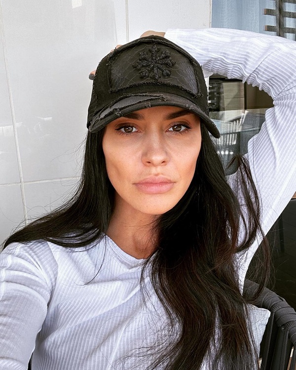 adelina chivu cu sapca neagra in cap si bluza alba