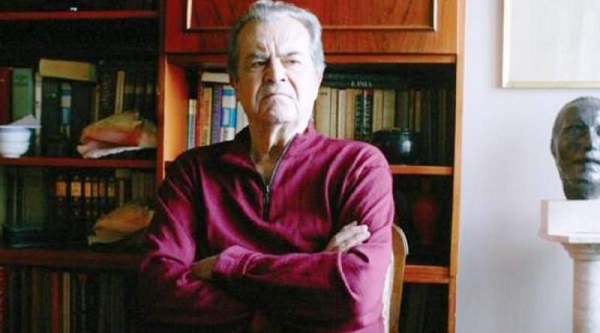 dumitru popescu in camasa rosie cu bratele incrucisate