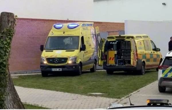 ambulanta de culoare galbena in spania langa o cladire