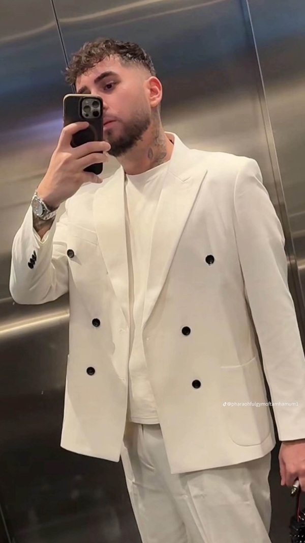 fulgy de la clejani imbracat in costum alb isi face un selfie in oglinda