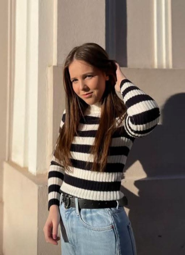 abigail imbracata in blugi cu bluza cu dungi si parul lung desprins