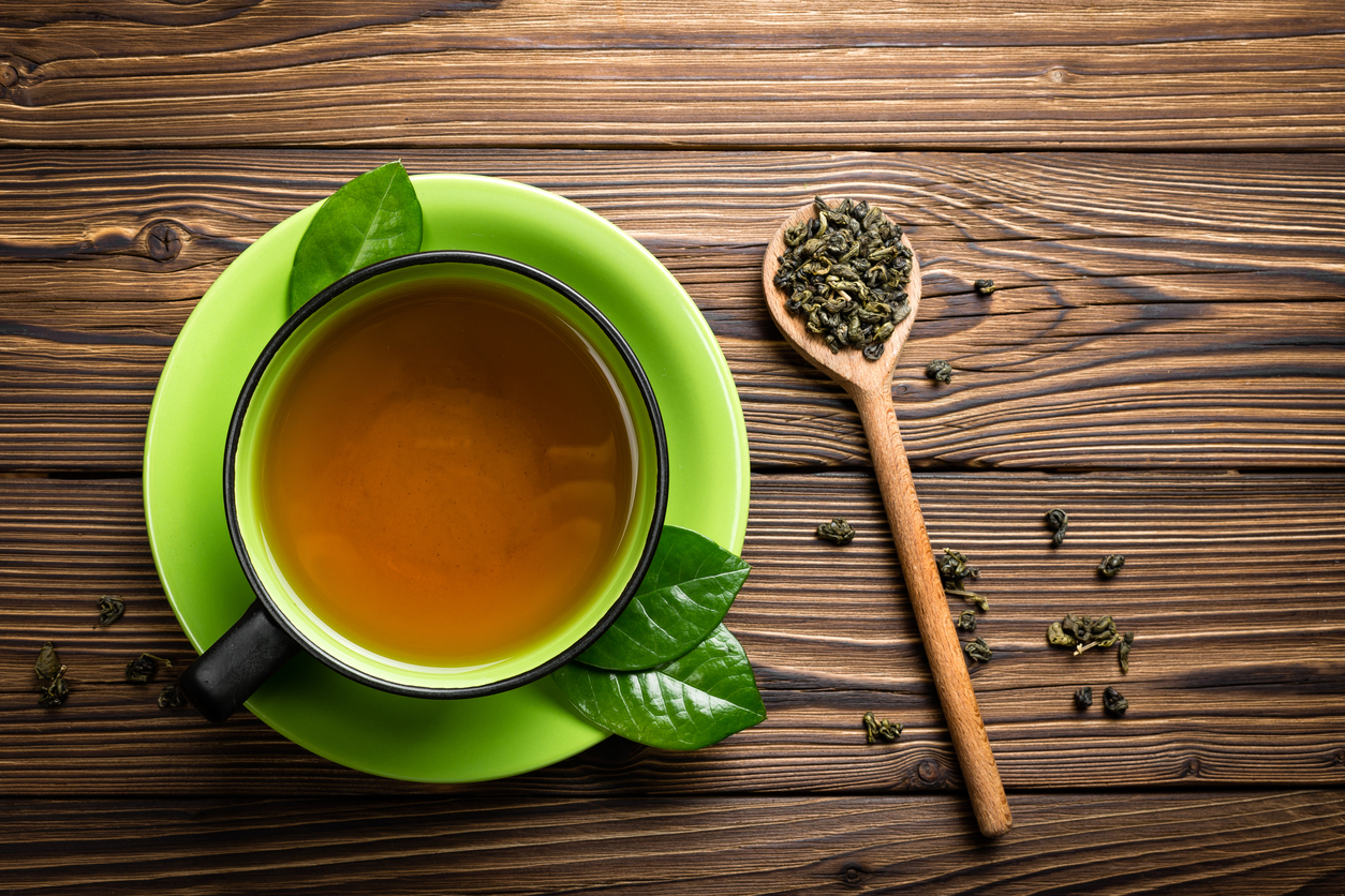 Cană de ceai verde pe farfurie