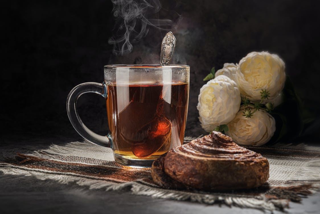 Cană de ceai și croisant pe masă 