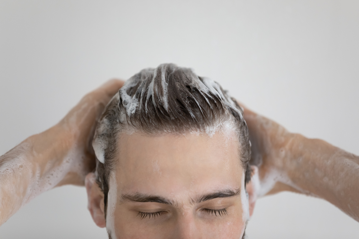 Bărbat care se spală pe cap