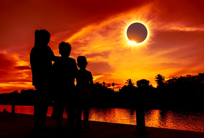 Copii care admiră eclipsa de soare