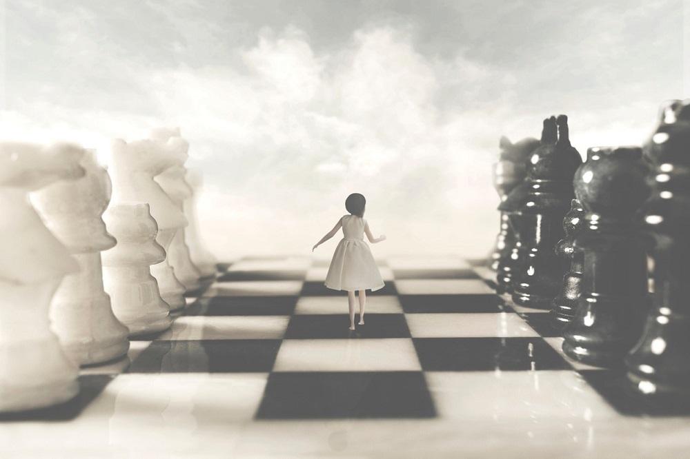 Ilustrație cu o fetiță care aleargă pe tabla de șah printre piese.