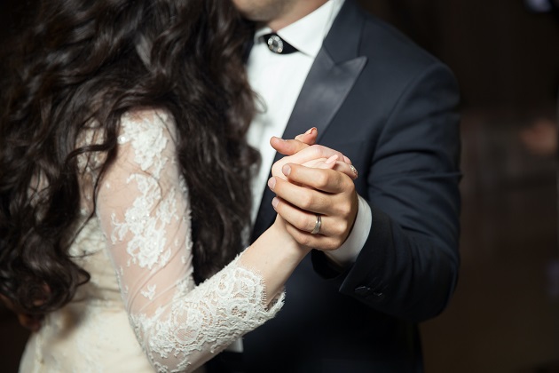 Parteneri care dansează apropiați la propria nuntă