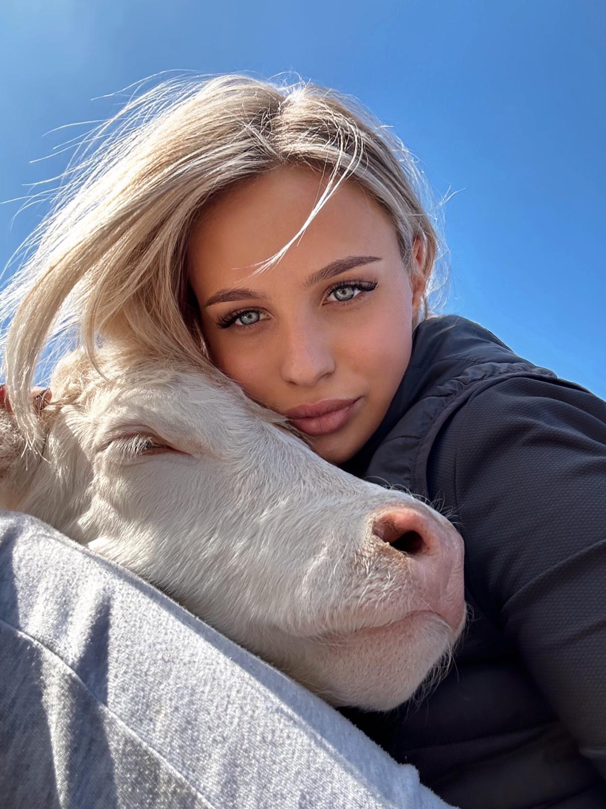 Andreea-Oana Arnăutu îmbrățișând o văcuță
