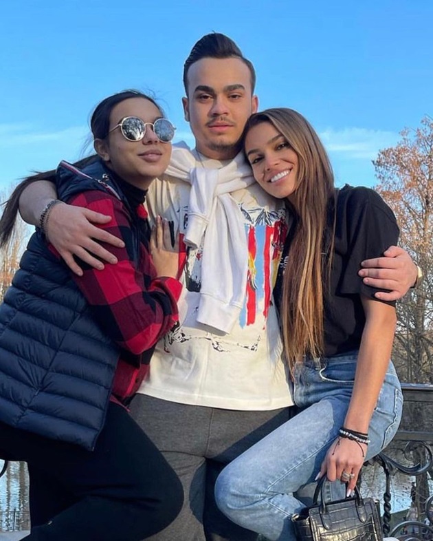 Adriana, Adrian și Karmen Simionescu îmbrățișați pe un pod care traversează un râu