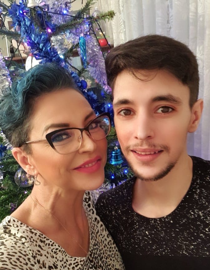Eugenia Șerban cu părul scurt și albastru, alături de fiul ei Lorans Bataineh, lângâ bradul de Crăciun