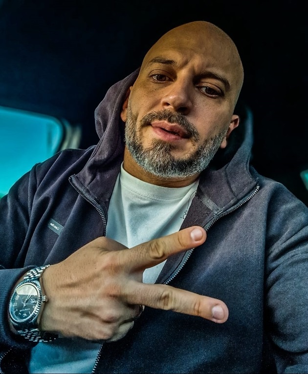 Radu Mateescu în mașină, îmbrăcat sport, cu gluga hanoracului pe cap