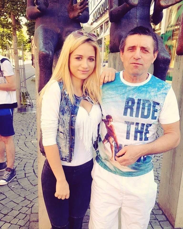 Maria Covașă sprijinindu-se de tatăl ei biologic, în timp ce stăteau împreună lângă niște statui