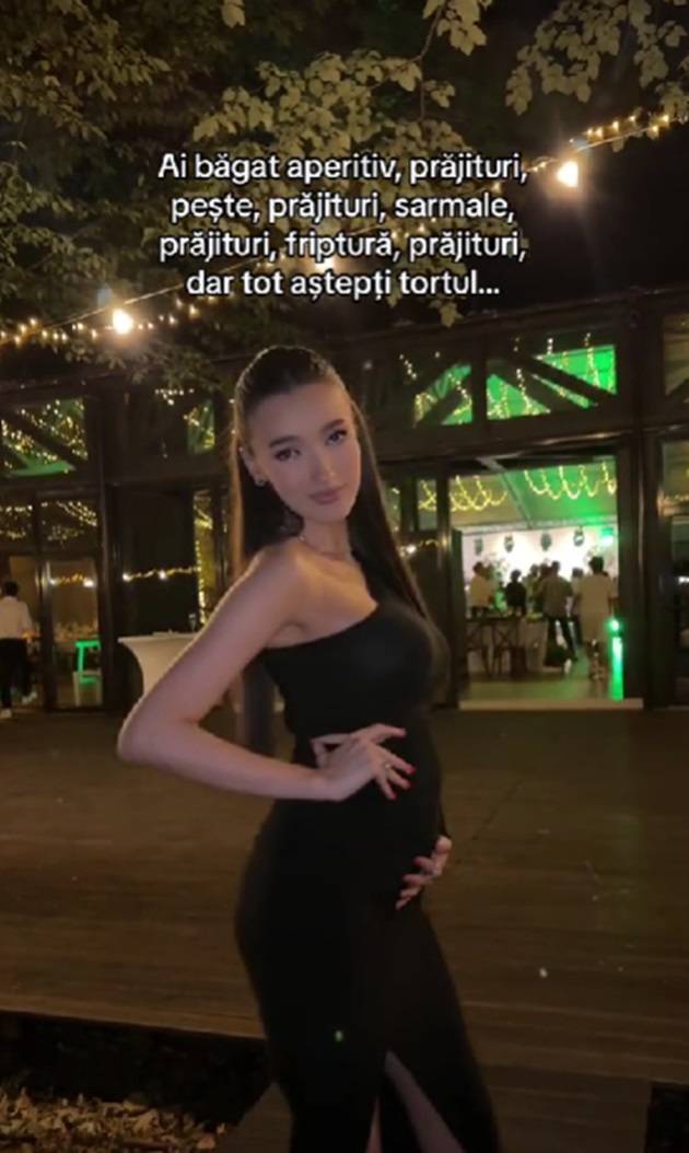 Viviana Sposub ținându-se de burtă, în timp ce se afla la o nuntă, îmbrăcată într-o rochie neagră mulată