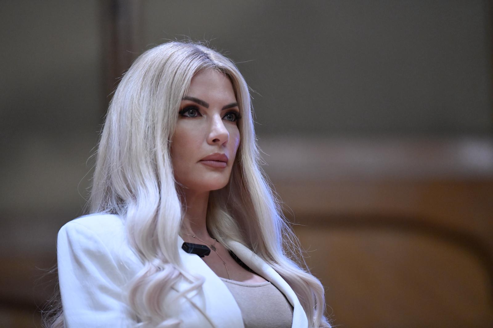 Laura Vicol îmbrăcată într-un maoiu de culoarea pielii și un sacou alb