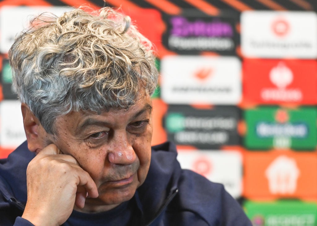 Mircea Lucescu gânditor, sprijinindu-și capul cu mâna, în timpul unei conferințe de presă