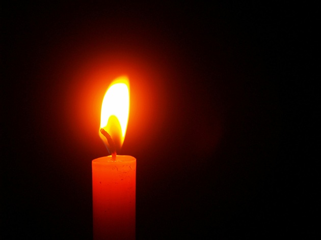 Lumânare aprinsă care arde în întuneric