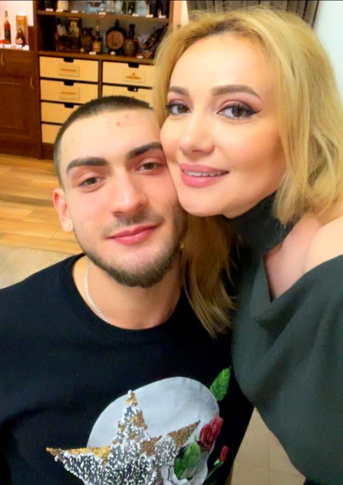 Adriana Ochișanu cuprinzându-l în brațe pe fiul ei, Cristian Botgros
