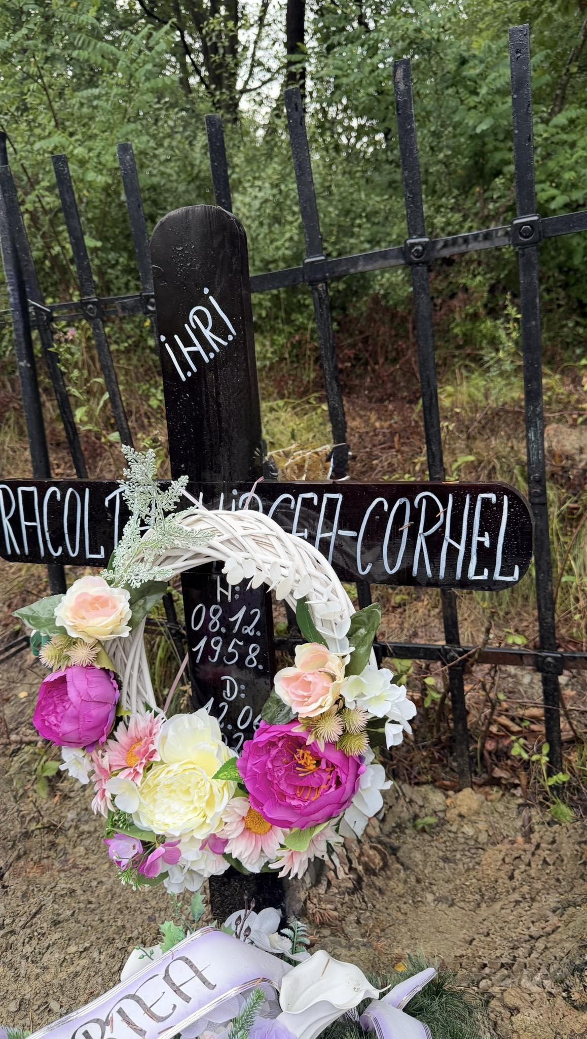 Crucea de la mormântul tatălui lui Carmen de la Sălciua, împodobită cu flori și coroane