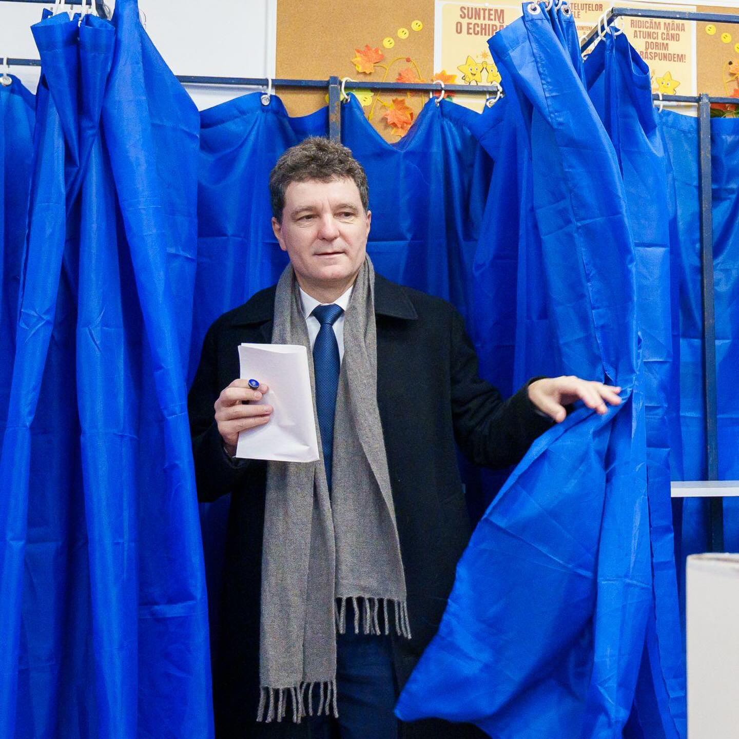 Nicușor Dan, cu buletinul de vot &icirc;n m&acirc;nă, ieșind din cabina de votare