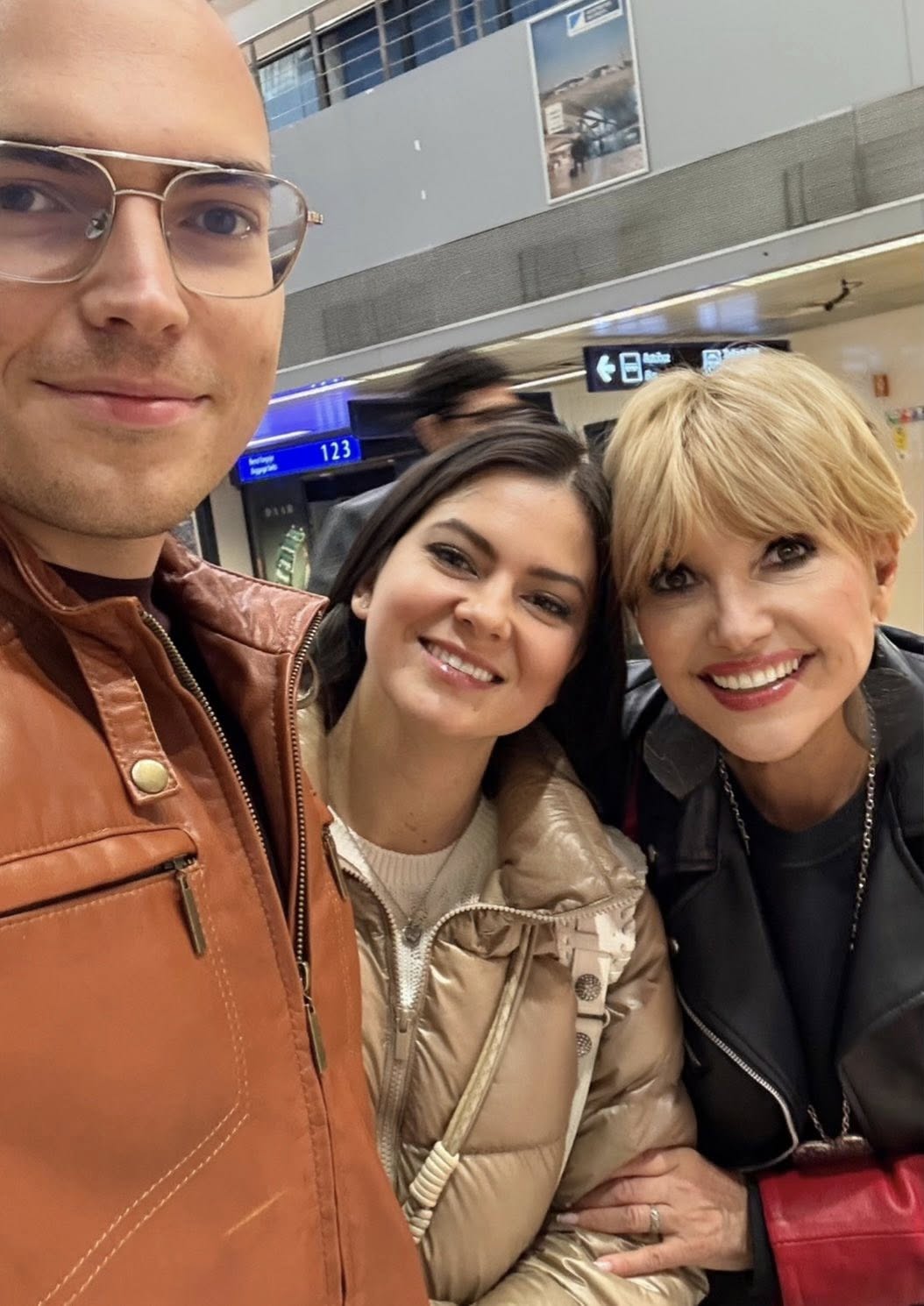 Marina Almășan alături de fiul și de nora sa, &icirc;n aeroport, &icirc;n timp ce z&acirc;mbeau toți &icirc;n fața camerei, &icirc;ncerc&acirc;nd să facă un selfie &icirc;mpreună