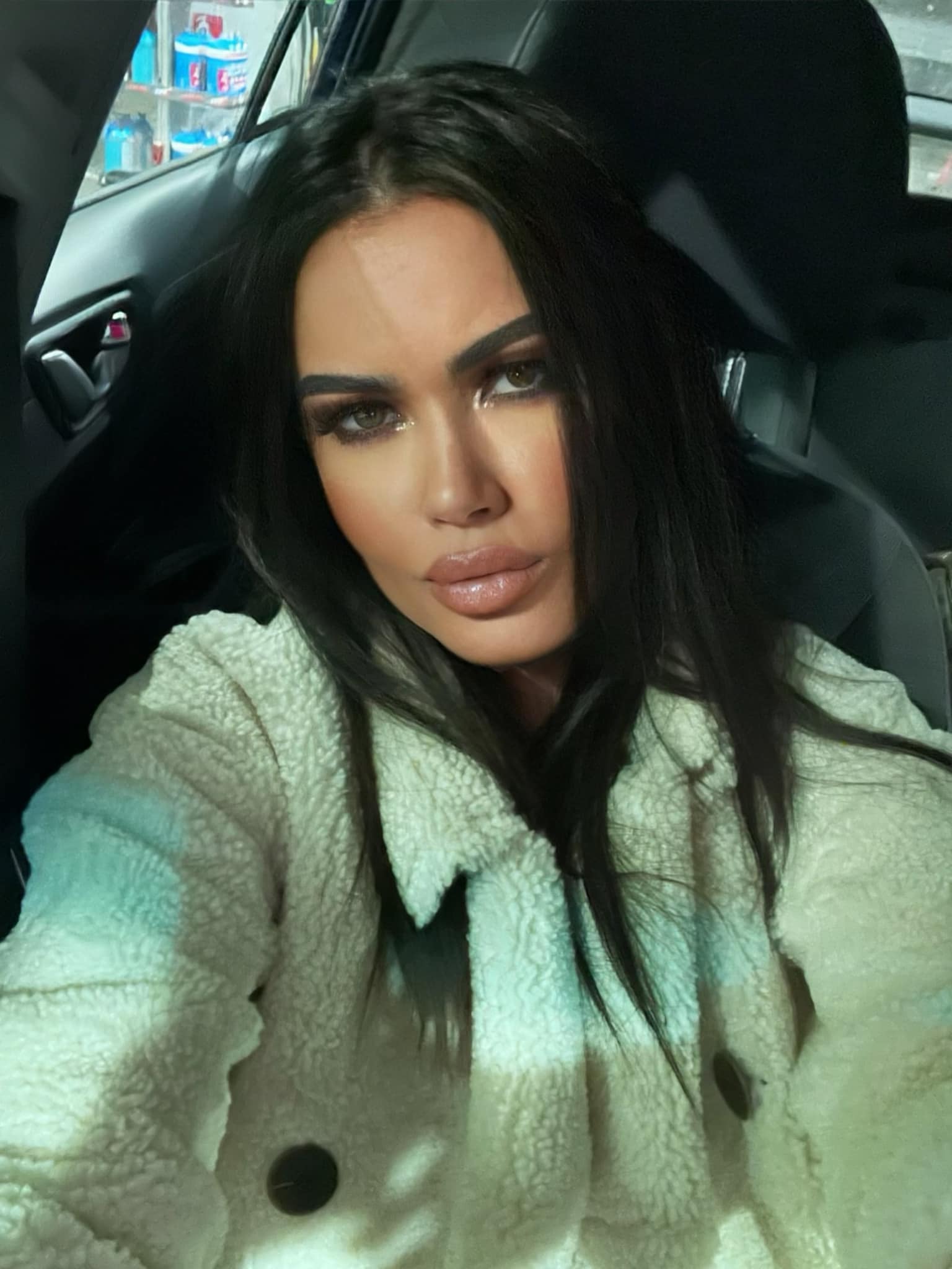 Oana Zăvoranu făc&acirc;ndu-și un selfie &icirc;n mașină, &icirc;n timp ce era &icirc;mbrăcată &icirc;ntr-o haină de blană albă