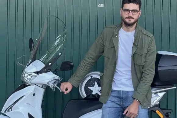 Alexandru Viorel Ichim, purt&acirc;nd ochelari și sprijinindu-se pe motorul său care era așezat &icirc;n fața unui garaj cu ușă meralică de culoare verde