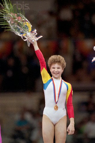 Daniela Silivaș la Jocurile Olimpice de la Seul, &icirc;mbrăcată &icirc;n costumul de gimnastică, cu o medalie la g&acirc;t, și cu flori &icirc;n m&acirc;nă