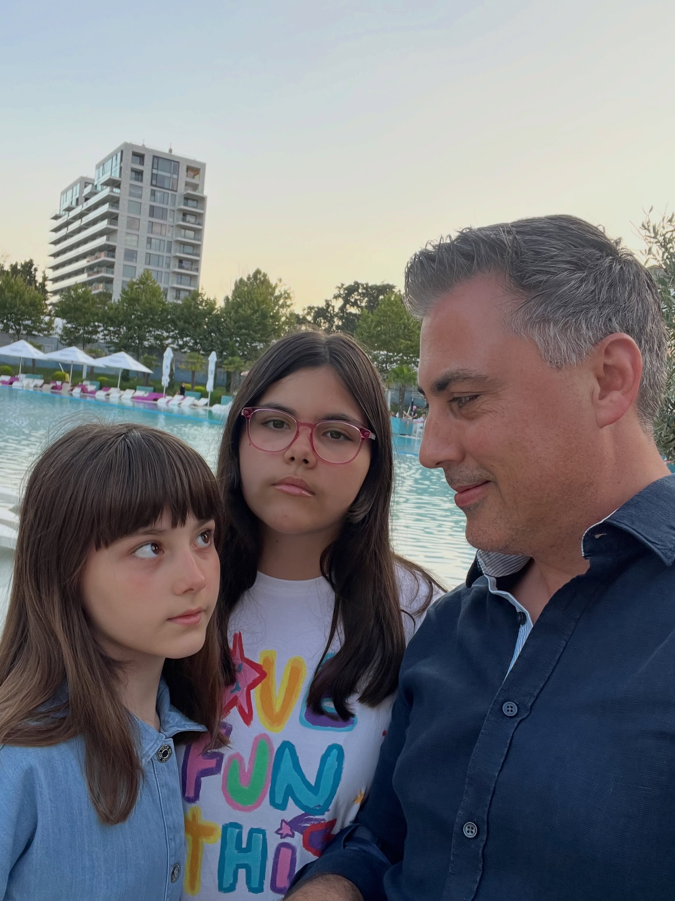 Alexandru Ciucu privindu-le z&acirc;mbitor pe fiicele sale, Carolina și Raisa, care stau serioase la poză, &icirc;n timpul vacanței lor prin Rom&acirc;nia