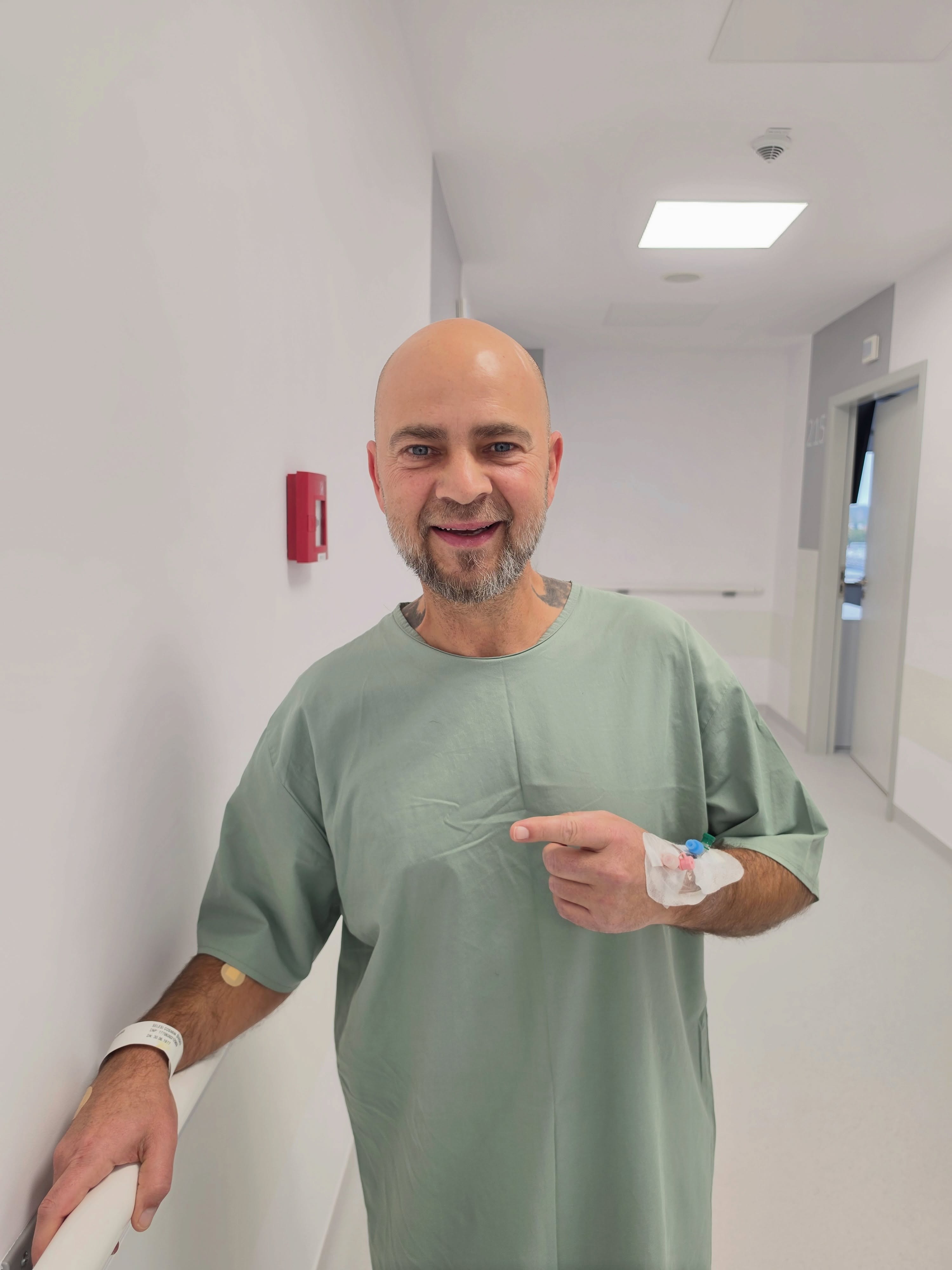 Cosmin Seleși în spital, după ce s-a ridicat din pat, la scurt timp după operația suferită, cu branula în mână, dar zâmbitor